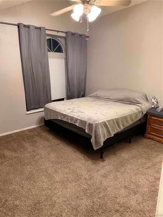 bedroom with carpet floors, ceiling fan, baseboards, and lofted ceiling