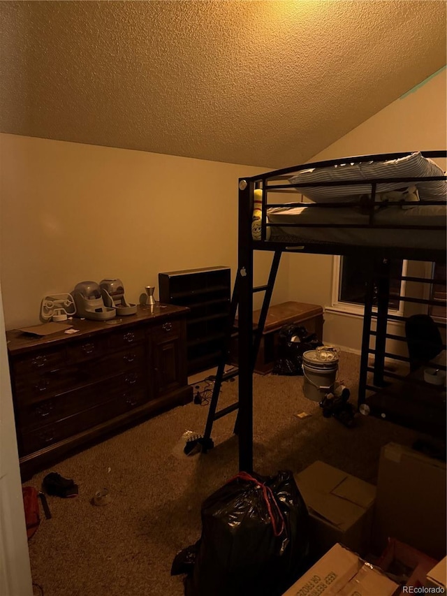 bedroom with a textured ceiling, vaulted ceiling, and carpet flooring