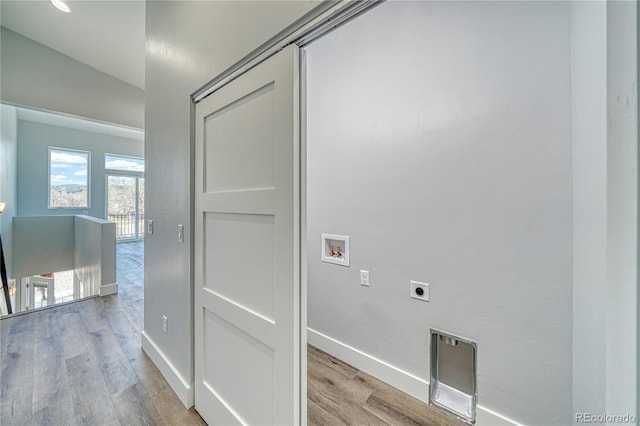 laundry area featuring hookup for an electric dryer, washer hookup, and light hardwood / wood-style flooring