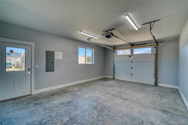 garage with a garage door opener and electric panel