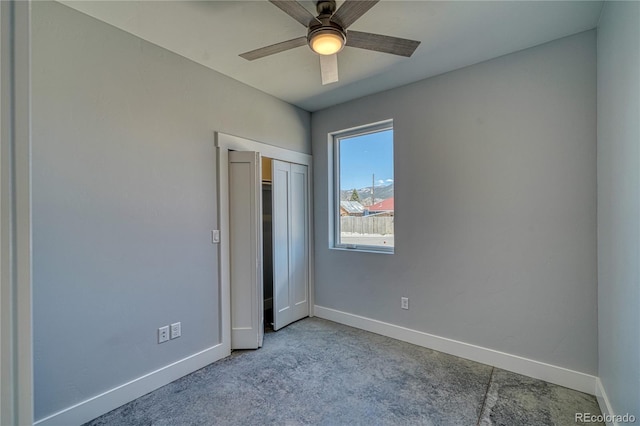 unfurnished bedroom with ceiling fan, a closet, and light carpet