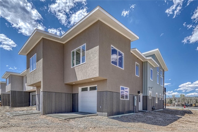 rear view of property with a garage