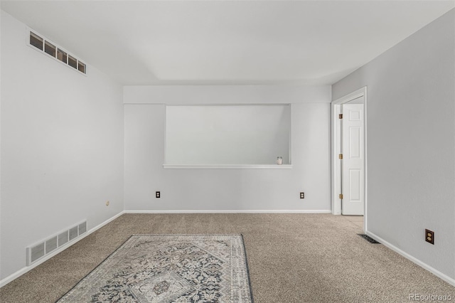 unfurnished room with carpet floors, baseboards, and visible vents