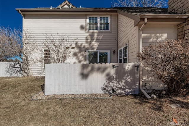 view of home's exterior with fence