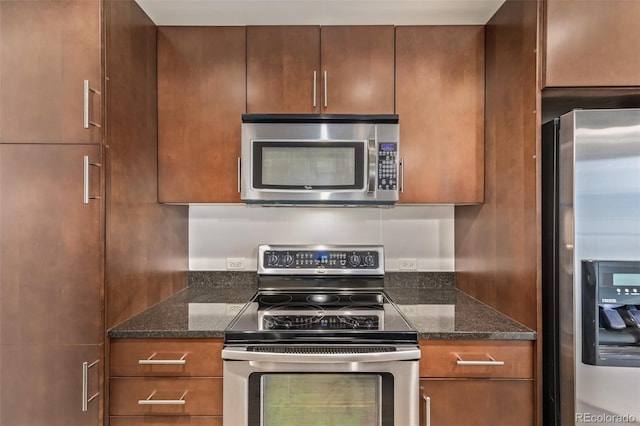 kitchen with stainless steel appliances, dark stone counters, and brown cabinetry