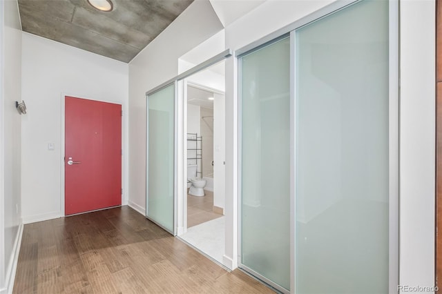 corridor featuring wood finished floors