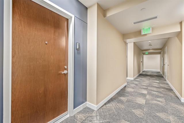 hall featuring carpet floors and baseboards