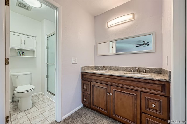 full bathroom featuring visible vents, a stall shower, toilet, and a sink