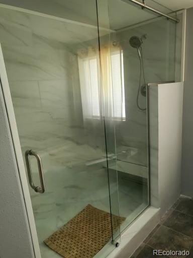 bathroom featuring tile patterned flooring and walk in shower