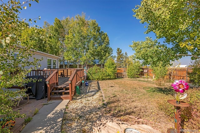 view of yard with a wooden deck