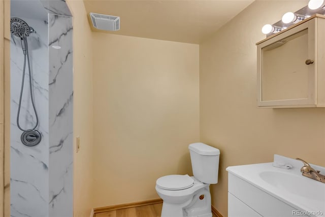 bathroom with hardwood / wood-style flooring, vanity, and toilet