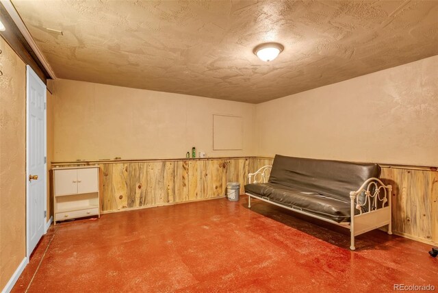 bedroom featuring wood walls