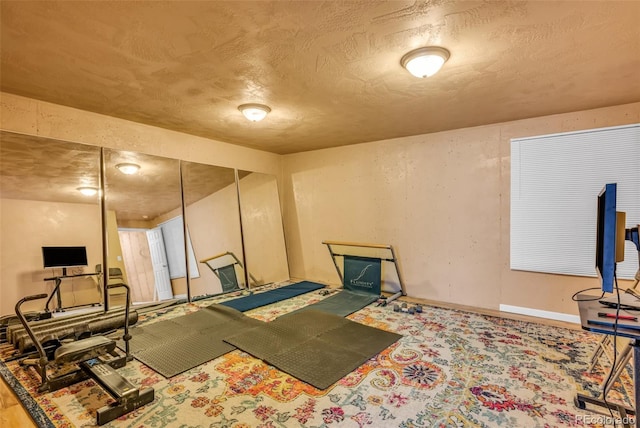 workout room with a textured ceiling