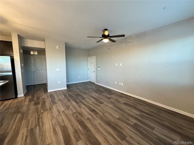 interior space with ceiling fan and dark hardwood / wood-style flooring