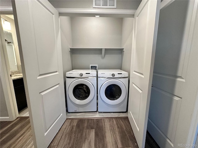 washroom with washer and clothes dryer and dark hardwood / wood-style floors