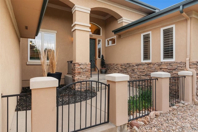 3806 S Dawson St, Aurora, CO 80014 - property entrance featuring stucco siding, a gate, and stone siding