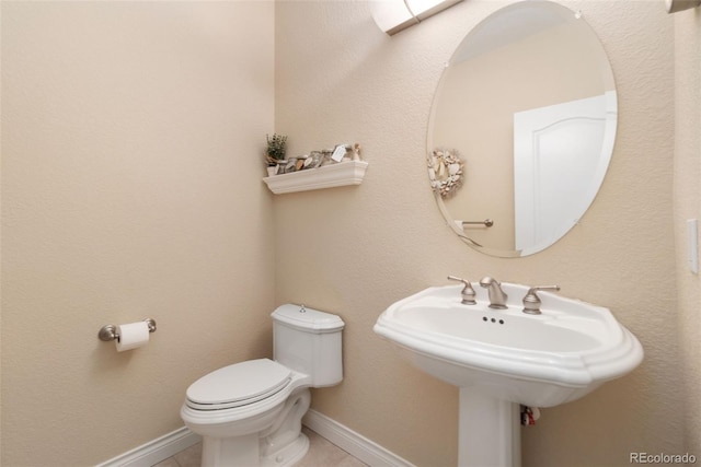 3806 S Dawson St, Aurora, CO 80014 - half bathroom with toilet, tile patterned flooring, baseboards, and a sink