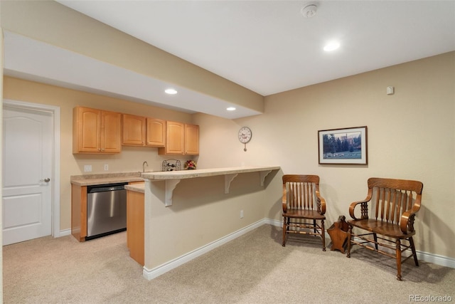 3806 S Dawson St, Aurora, CO 80014 - kitchen with dishwasher, a breakfast bar, light colored carpet, light brown cabinets, and light countertops