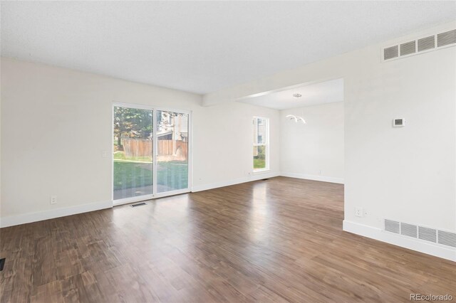 1519 S Sable Blvd Unit C, Aurora, CO 80012 - unfurnished room with wood finished floors, baseboards, and a chandelier
