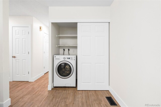 1519 S Sable Blvd Unit C, Aurora, CO 80012 - laundry area with washer / clothes dryer, light wood finished floors, and baseboards
