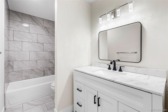 1519 S Sable Blvd Unit C, Aurora, CO 80012 - bathroom featuring marble look tile flooring, vanity, toilet, and shower / washtub combination