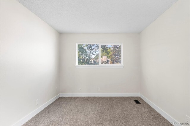 1519 S Sable Blvd Unit C, Aurora, CO 80012 - spare room featuring carpet flooring, baseboards, and a textured ceiling