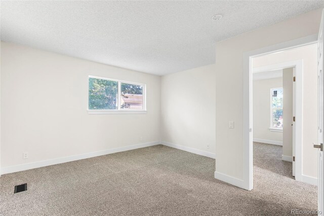 1519 S Sable Blvd Unit C, Aurora, CO 80012 - unfurnished room with carpet, healthy amount of natural light, a textured ceiling, and baseboards