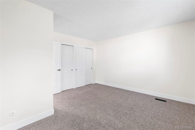 1519 S Sable Blvd Unit C, Aurora, CO 80012 - unfurnished bedroom with carpet flooring, baseboards, a closet, and a textured ceiling