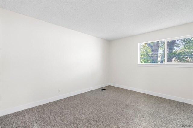 1519 S Sable Blvd Unit C, Aurora, CO 80012 - spare room featuring carpet flooring, a textured ceiling, and baseboards
