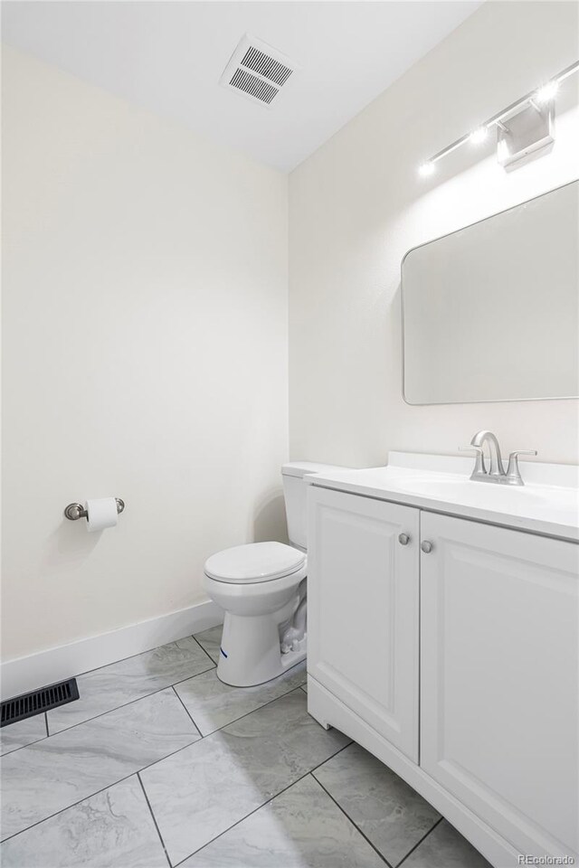 1519 S Sable Blvd Unit C, Aurora, CO 80012 - bathroom featuring marble finish floors, vanity, toilet, and baseboards