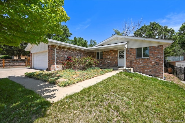 6432 Zephyr St, Arvada, CO 80004 - ranch-style home featuring an attached garage, brick siding, and driveway