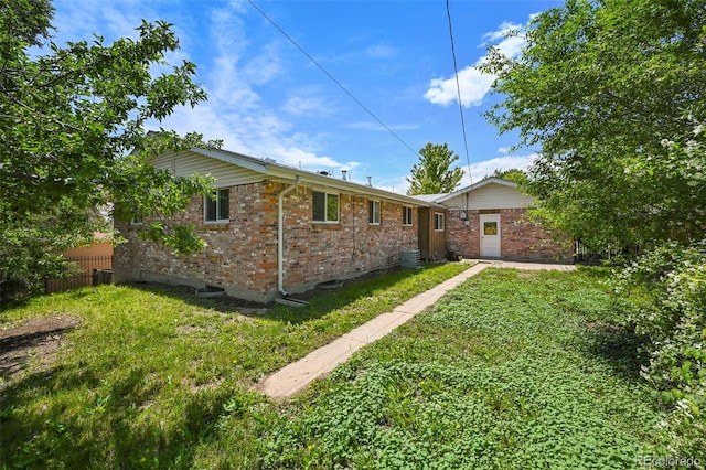 6432 Zephyr St, Arvada, CO 80004 - view of home's exterior with brick siding and central air condition unit
