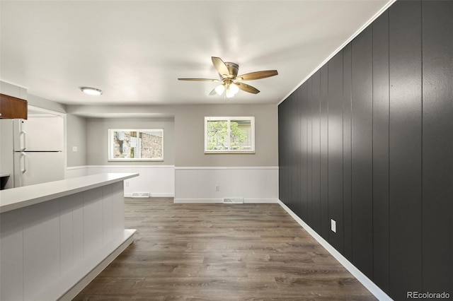 6432 Zephyr St, Arvada, CO 80004 - unfurnished living room with a ceiling fan, dark wood finished floors, and baseboards