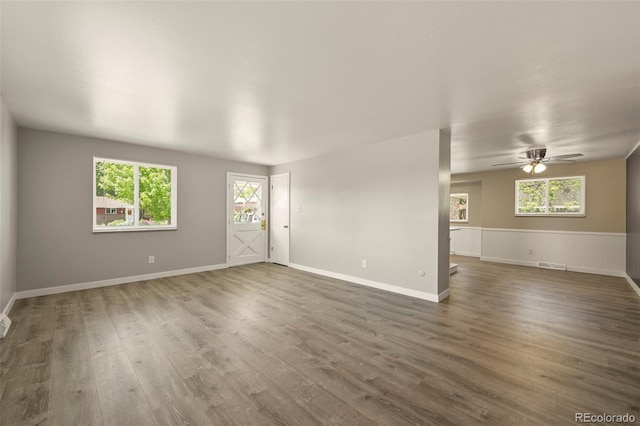 6432 Zephyr St, Arvada, CO 80004 - unfurnished room featuring plenty of natural light, a ceiling fan, wood finished floors, and baseboards