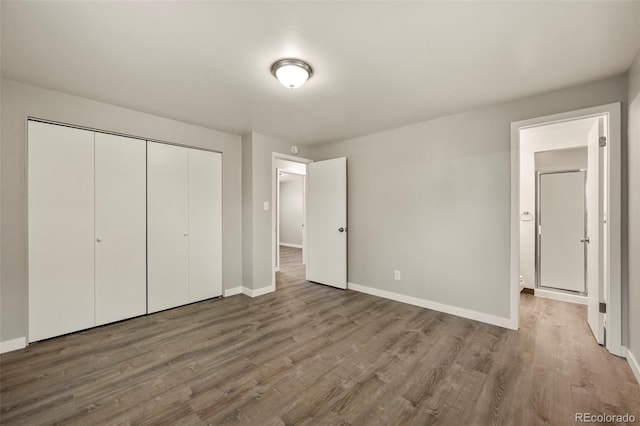 6432 Zephyr St, Arvada, CO 80004 - unfurnished bedroom with baseboards, wood finished floors, and a closet