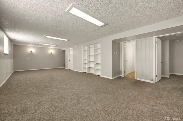 6432 Zephyr St, Arvada, CO 80004 - below grade area with dark colored carpet, a textured ceiling, built in features, and baseboards