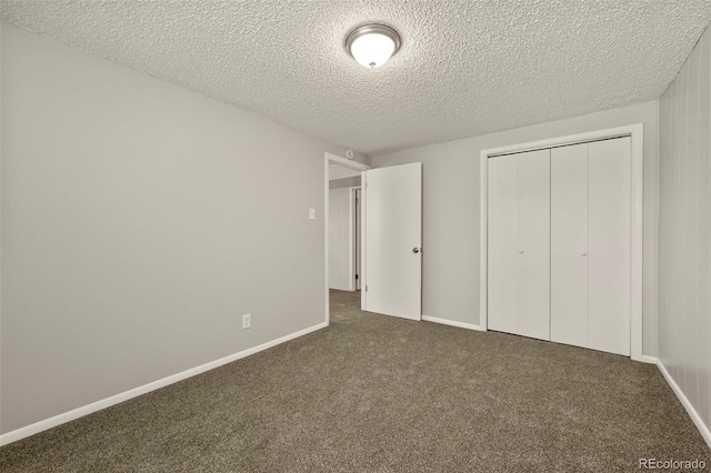 6432 Zephyr St, Arvada, CO 80004 - unfurnished bedroom with dark carpet, a textured ceiling, a closet, and baseboards