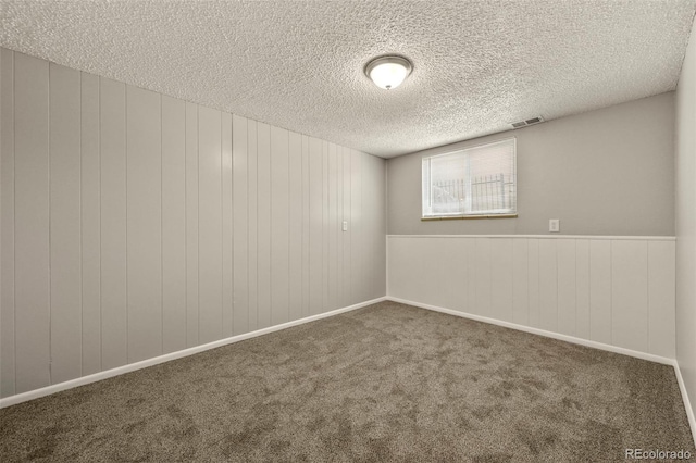 6432 Zephyr St, Arvada, CO 80004 - carpeted empty room featuring a textured ceiling and wooden walls