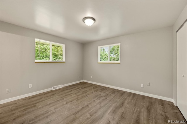 6432 Zephyr St, Arvada, CO 80004 - empty room featuring healthy amount of natural light, wood finished floors, and baseboards