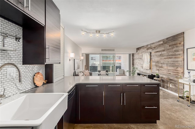 1121 Albion St Unit 809, Denver, CO 80220 - kitchen with a sink, a peninsula, black dishwasher, dark brown cabinetry, and light countertops