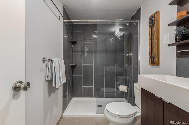 1121 Albion St Unit 809, Denver, CO 80220 - bathroom featuring toilet, vanity, a stall shower, and tile patterned floors