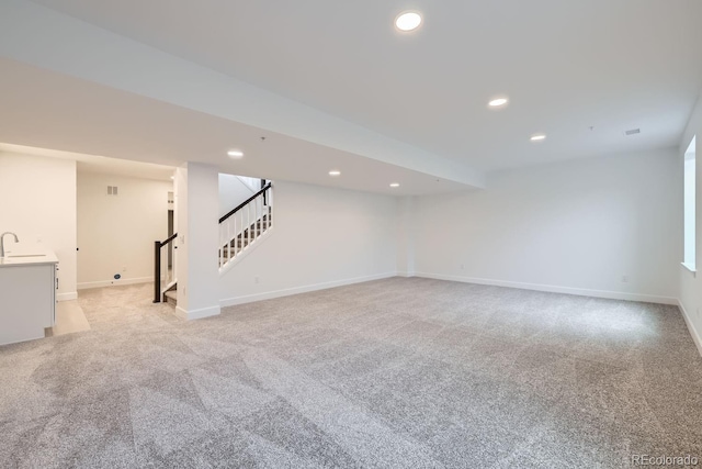 interior space featuring sink and light colored carpet