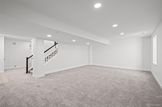 basement featuring light colored carpet