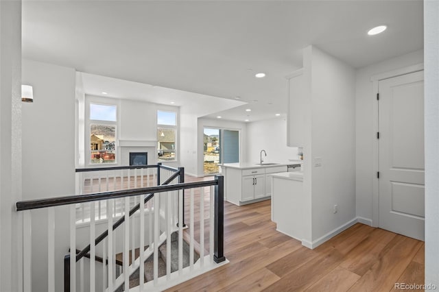 hall featuring sink and light hardwood / wood-style flooring