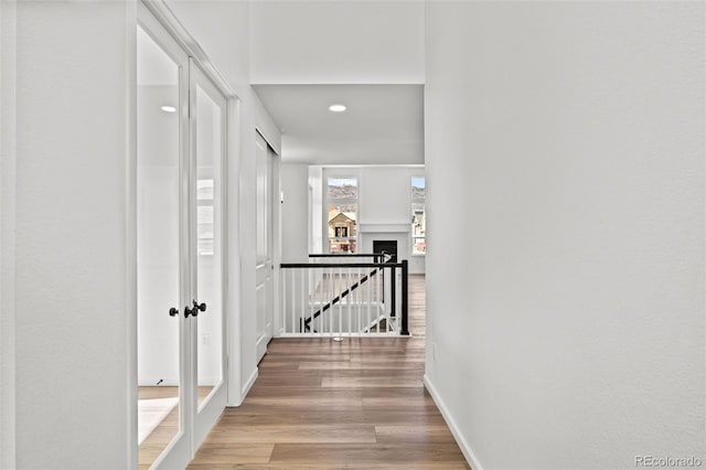 hallway with light hardwood / wood-style floors