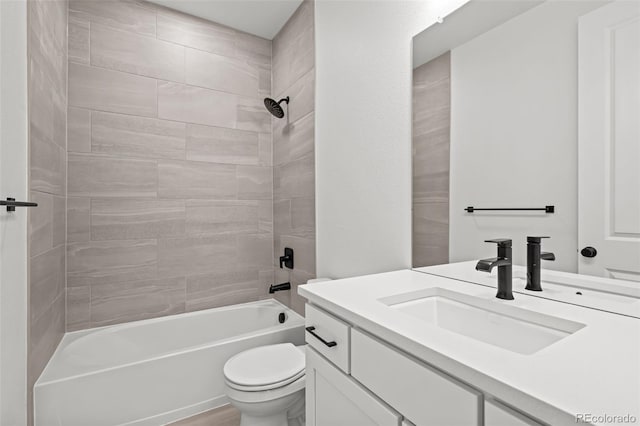 full bathroom with vanity, toilet, and tiled shower / bath combo