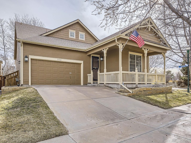 view of front of property with a porch, an attached garage, roof with shingles, and concrete driveway