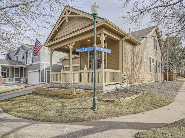 view of front of home featuring a porch, concrete driveway, and an attached garage