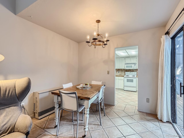 tiled dining area with an inviting chandelier