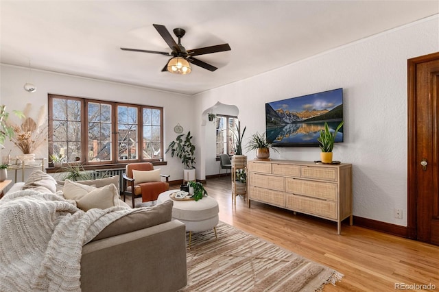 living room featuring ceiling fan and light wood-type flooring